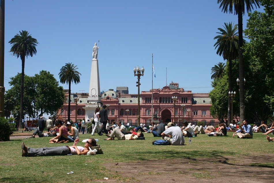 people resting on grass on Plaza de Mayo, argentina, buenos aires