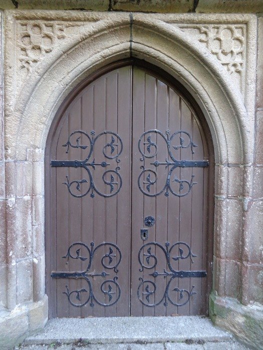 arched wooden door to the church