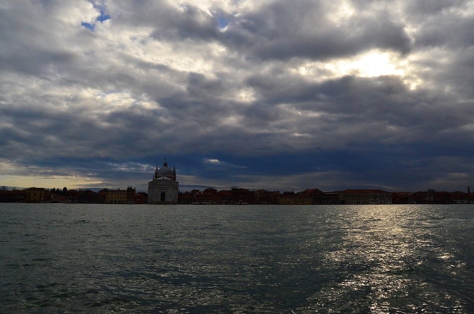 canal in venice under dark clouds