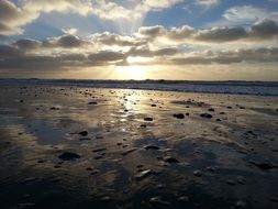 The beach of the northern sea in the glare of the sun