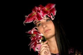 beautiful girl with green eyes, her hair decorated by lily flowers