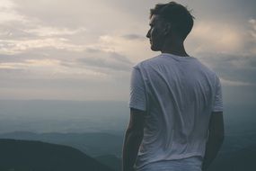 standing man looking male sky