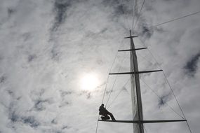 man on the sailboat mast