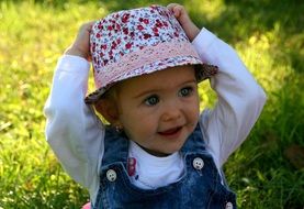 little girl with blue eyes in a panama hat