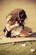 girl with curly hair takes photography