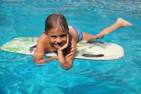 boy on the bodyboard in the pool