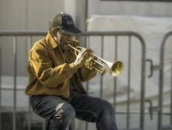 man on street playing trumpet