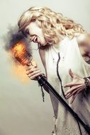 Blond girl sings into a burning microphone