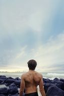 muscular back of surfer man fit lifestyle