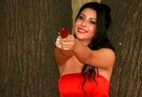 girl in a red dress with a rose in her hands