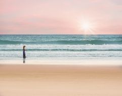 girl walking sea shore sunset