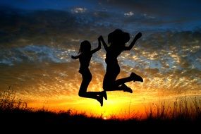 girls in the air at sunset