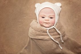 photo of baby in a white cap