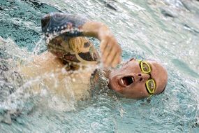 man swimming in the pool in competitions