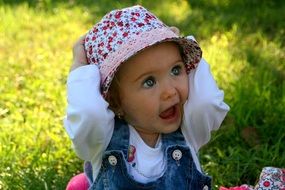 portrait of a baby girl with blue eyes in a hat