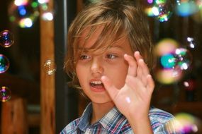 boy playing with soap bubbles