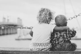 Kids sit on the waterfront