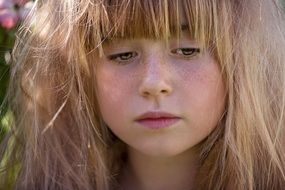 sad face of a blond girl