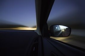 car's mirror at dusk
