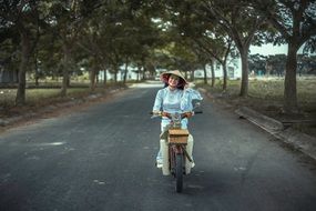happy asian woman on the moped