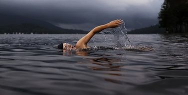 swimmer in dark lake