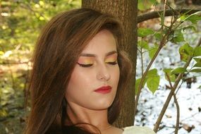 portrait of a girl with eyes closed in the forest
