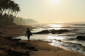 man walking on the ocean beach