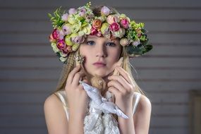 portrait of the beauty girl is wearing a wreath