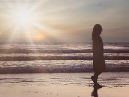 female silhouette on the ocean beach