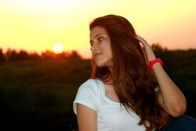 girl looking to the side at sunset background