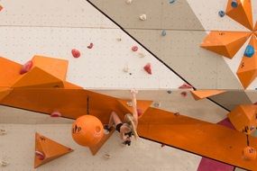 rock climbing girl on a colorful wall