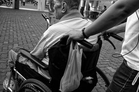 Black and white photo of the man in a wheelchair