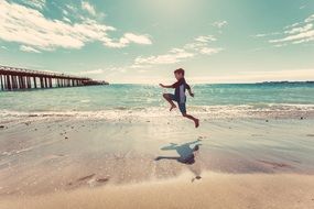 boy jumping on the ocean beach