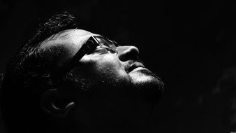 man in eyeglasses looking up, black and white portrait