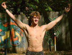 shirtless man shows victory