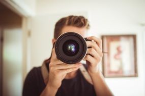 person with camera at face, lens close up