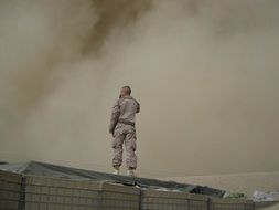 soldier walking throught the smoke