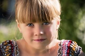 close portrait of a blond girl child