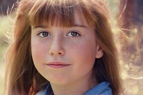 freckles on the little girl face