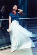 posing pretty woman in the white skirt