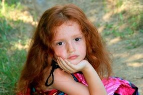 beautiful red haired child girl looking straight outdoor