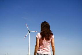 the girl on the background of a wind generator