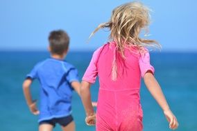 children running on a beach