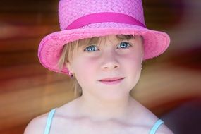 child in pink hat
