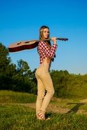 grass and girl with guitar