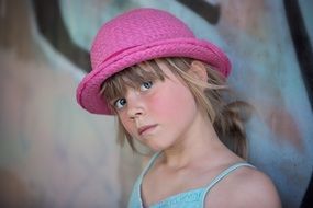 young girl in pink hat