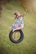 young girl playing in the swing