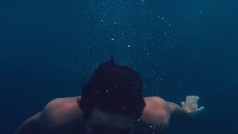 man is drowning in water