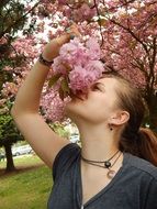 girl on the background of a blooming spring tree