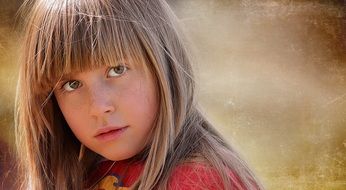 portrait of a blond girl child in the park